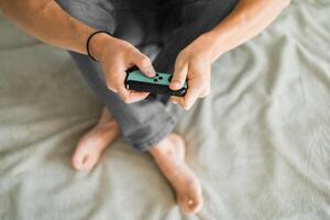 Man playing on the game console. Holding hands gamepad, game controller photo