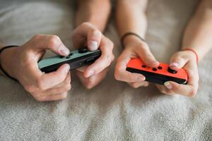 Woman and man playing on the game console. Holding hands gamepad, game controller photo