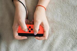 Woman playing on the game console. Holding hands gamepad, game controller photo