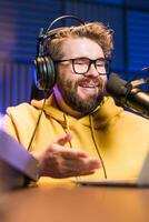 Handsome man radio DJ hosting a radio show, entertainment and communication concept photo
