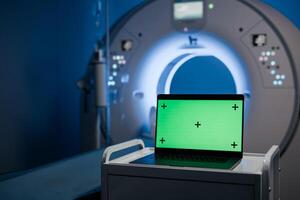 Computed tomography scan, green mock-up on laptop. Medical research environment software with CT scan results. AI artificial intelligence medical diagnosis concept photo