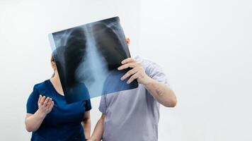 Two doctors in an MRI or CT room reviewing images and discussing the results. The concept of teamwork and precise analysis for diagnosing conditions of organs and the bone system. Copy space, banner photo