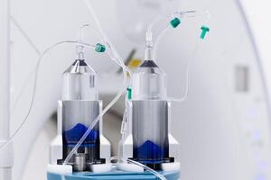 Close-up of a contrast agent before diagnostics in a CT room. The concept of using innovative technologies for accurate vascular examinations. Banner, free copy space. advertising. Medicine concept photo