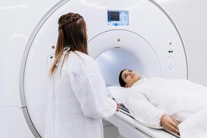 A doctor consults and prepares a patient for MRI or CT diagnostics in a modern diagnostic center. The concept of high-quality medical care and innovative technologies. photo