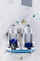 Close-up of a contrast agent before diagnostics in a CT room. The concept of using innovative technologies for accurate vascular examinations. Vertical shot, medicine photo