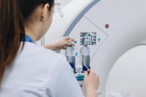 Back view of female doctor assists a patient undergoing an MRI scan, showcasing professionalism and modern medical technology in a healthcare setting. photo