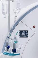 Close-up of a contrast agent before diagnostics in a CT room. The concept of using innovative technologies for accurate vascular examinations and disease diagnostics. Medicine concept, Vertical shot photo