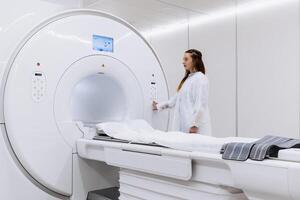 A professional radiologist in uniform preparing the MRI scanning process in a clinic. MRI or CT capsule in a modern diagnostic center. The concept of cutting-edge technologies and precise diagnostics. photo