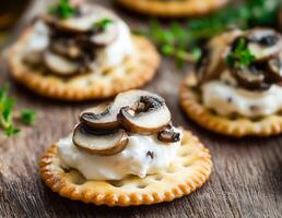 Delicious appetizer with creamy cheese and cooked mushrooms on a crispy cracker, perfect for a casual gathering. photo
