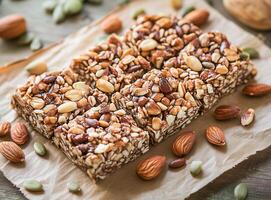 Nutritious snack bars made with assorted nuts and seeds on a rustic wooden table, perfect for a healthy treat any time of the day photo