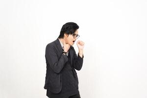 A man in glasses and a jacket is standing in front of a white background photo