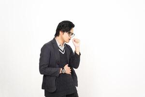 A man in glasses and a sweater standing against a white wall photo