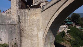 The famous old arch bridge in Mostar. Close-up view of the summer tourist attraction of the famous bridge symbol of the city video