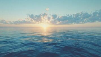 A sunset over the ocean with clouds photo