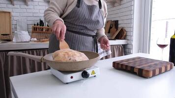 closeup woman making Ossetian pie with potatoes and cheese on the frying pan video
