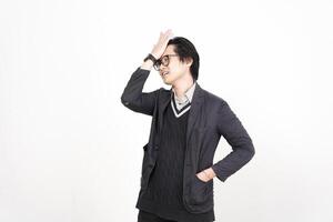 A man in a sweater and jacket standing in front of a white background photo