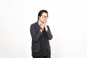 A man in glasses and a jacket standing in front of a white background photo