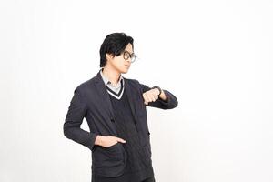 A man in glasses and a jacket is standing in front of a white background photo