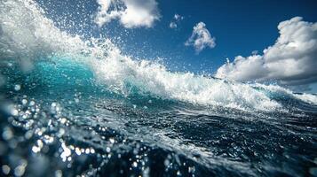 A wave breaking on the ocean with blue sky photo