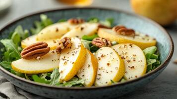 A bowl of salad with apples, pecans and nuts photo