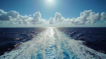 The sun shines on the ocean as it travels through the water photo