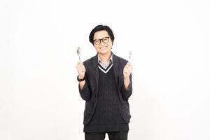 A man in glasses holding two forks and a knife photo
