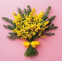 Bouquet of mimosa flowers on pink background photo