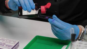 Scientist Staining Microscope Slide for Laboratory Analysis video