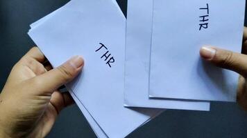 Count several envelopes labeled THR with a black background. This envelope contains an allowance of 1 month's salary, which in Indonesia is usually given to employees before the Eid al-Fitr holiday video