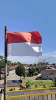 Close up view of the red and white flag flying at a height video