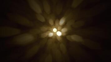 Defocused golden bokeh lights background. This elegant motion background animation with hexagonal lens blur bokeh particles is full HD and looping. video