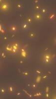 Abstract background with glowing orange and yellow particles resembling sparks or embers. Warm-toned, blurred effect creating a soft glowing atmosphere video