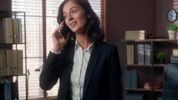 Caucasian woman talking mobile phone smartphone call smiling office female girl cellphone businesswoman communication distant worker manager consultation client chatting business indoor conversation video
