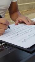 Man Writes Chords On Sheet Music And Study On Keyboard Instrument video