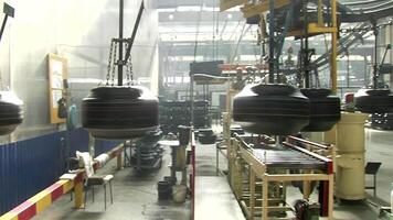 Formed tires workpieces moving on giant conveyor at the giant rubber workshop stock . Car tires plant at works process video
