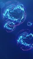 Abstract energy spheres in blue and pink floating against a dark background, depicting a futuristic and dynamic concept video