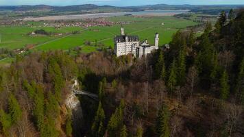 Aerial view Neuschwanstein Castle and bridge Marienbrucke across Pollat gorge in Ammergau Alps. View of famous Neuschwanstein Castle, Fussen, Bavaria, Germany and Marys bridge over cliff video