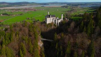 Aerial view Neuschwanstein Castle and bridge Marienbrucke across Pollat gorge in Ammergau Alps. View of famous Neuschwanstein Castle, Fussen, Bavaria, Germany and Marys bridge over cliff video