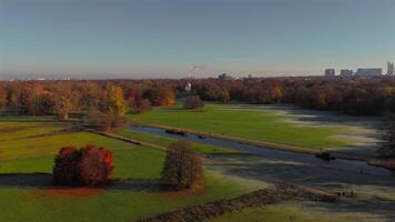 Schwabinger Bach is stream in Munchen, Bavaria, Germany. Starts in centre of Munich, flows through Englischer Garten and flows into Isar river. Schwabinger Bach aerial view in autumn in sunny weather. video