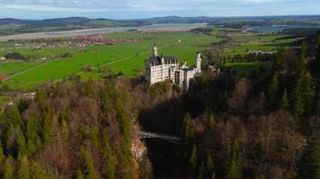 Aerial view Neuschwanstein Castle and bridge Marienbrucke across Pollat gorge in Ammergau Alps. View of famous Neuschwanstein Castle, Fussen, Bavaria, Germany and Marys bridge over cliff video