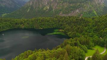 Drone views of Freibergsee and Heini-Klopfer- Schkiflugschanze in Bavaria, Germany. Surrounded by mountains and forests, this pristine lake and famous ski jump is an aerial view of area. Oberstdorf. video