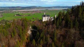 Aerial view Neuschwanstein Castle and bridge Marienbrucke across Pollat gorge in Ammergau Alps. View of famous Neuschwanstein Castle, Fussen, Bavaria, Germany and Marys bridge over cliff video