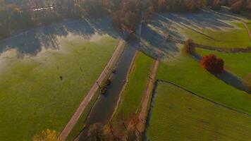 Schwabinger Bach is stream in Munchen, Bavaria, Germany. Starts in centre of Munich, flows through Englischer Garten and flows into Isar river. Schwabinger Bach aerial view in autumn in sunny weather. video