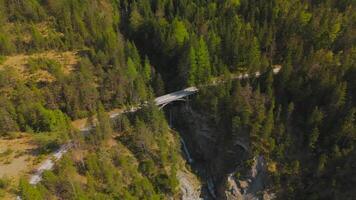 Luftaufnahme Schurpfen Wasserfall. Aerial view of crooked waterfall Schurpfen and bridge in gorge with forested mountain and canyon near Sylvensteinspeicher in Lenggries. Drone view falls and bridge. video
