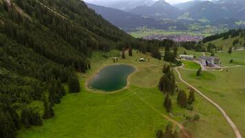 Aerial view Nebelhorn snowmaking pond in Oberstdorf collects water for artificial snow, supporting skiing activities despite variable natural snowfall. Supporting sustainable snow coverage in Alps. video