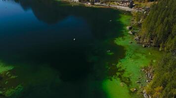 Hintersee in Ramsau, Germany captured from above in autumn, features turquoise waters of Ramsauer Ache, majestic Alps and Magic Forest. Enjoy boat rentals on this tranquil lake perfect for relaxation. video