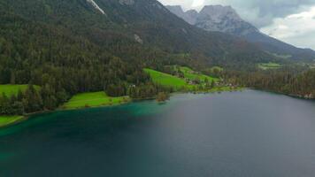 Hintersteiner See mountain lake in Austria near town of Kufstein, aerial view in summer at sunset in cloudy weather. Hintersteiner See in Oesterreich in der Nahe der Stadt Kufstein Luftaufnahme. video