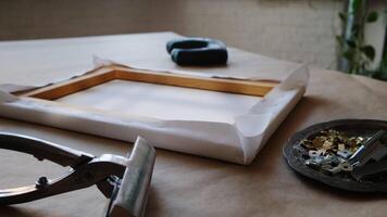 Canvas framing. Cotton canvas on stretcher, tools and accessories for stretching the canvas on stretcher. video