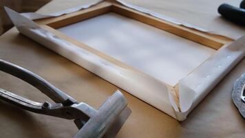 Canvas framing. Tools and accessories for stretching canvas on stretcher frame. video