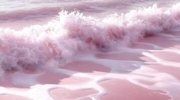 Pink waves crashing on sandy beach, sunlight photo